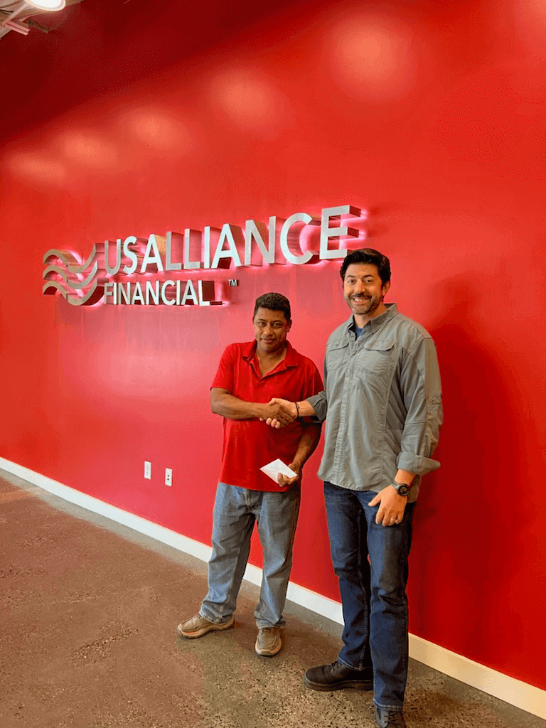 Albino is shaking hands and receiving his check