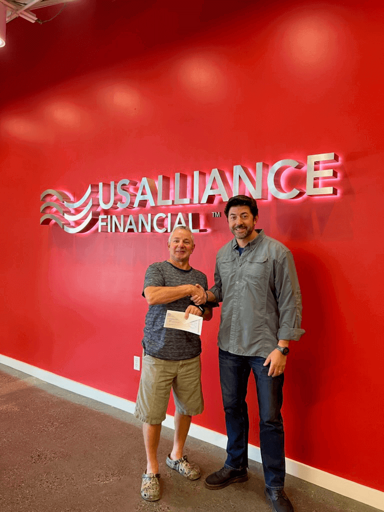 John is shaking hands and receiving his check